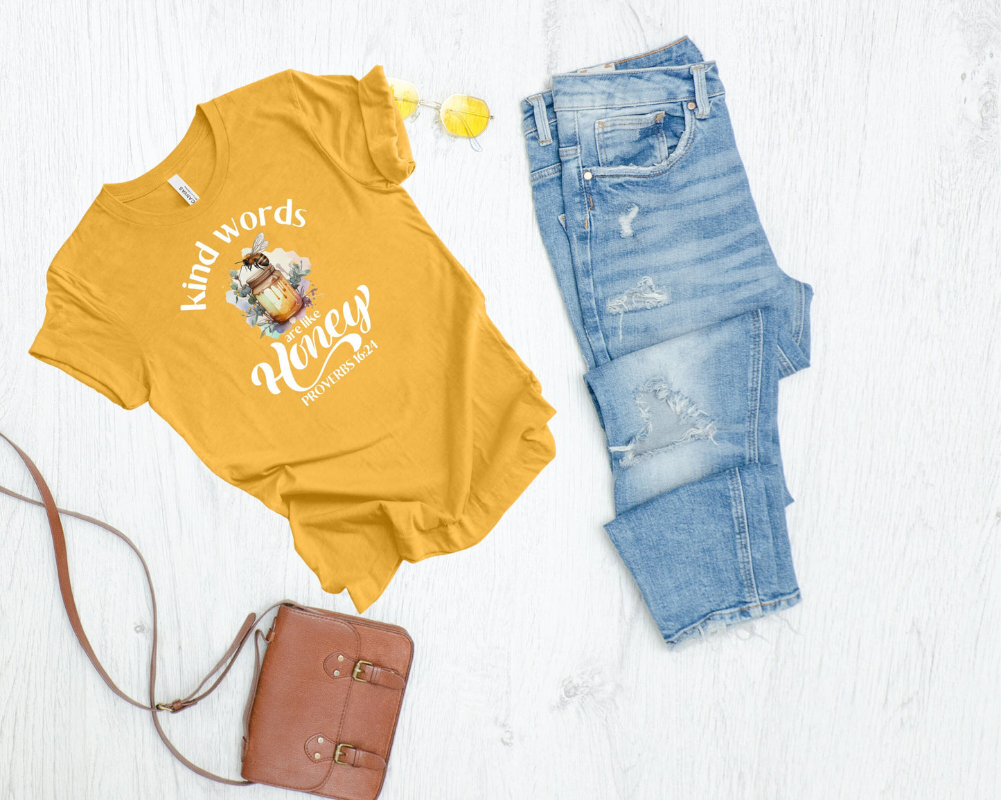 Golden yellow tee with a full color jar of honey and tee in watercolor, plus the verse from Proverbs 16:24 that says kind words are like honey.