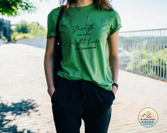 Kelly green tee on a model standing on a boardwalk. The words &quot;Strength for Today and Bright Hope for Tomorrow&quot; on the front of the shirt.